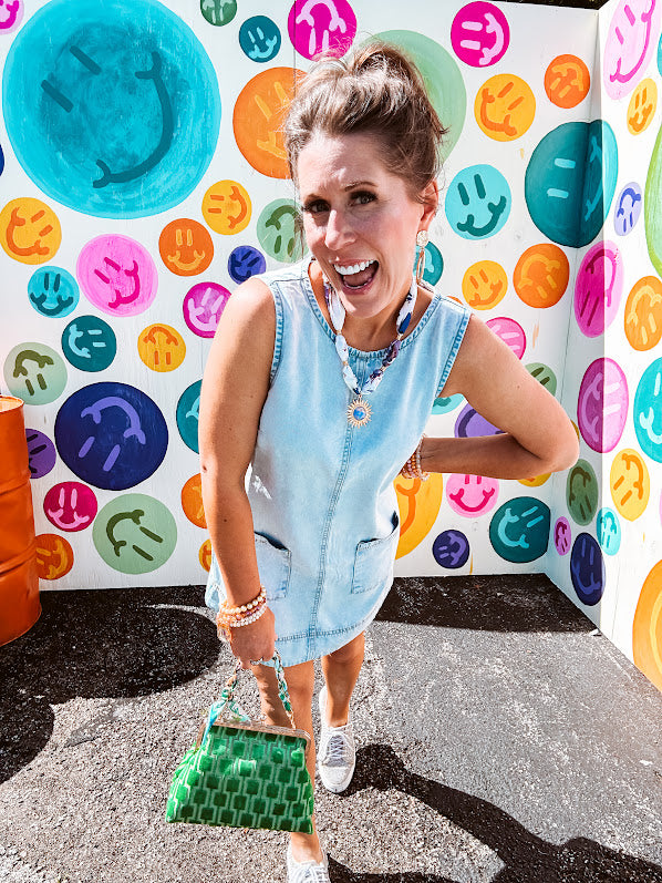 light-washed denim mini dress, lightweight lyocell fabric with front pocket detail and  hook-and-eye back closure.