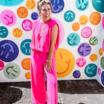 Fuchsia set including a bubble hem, sleeveless blouse with pleated shoulders and wide-leg pants with pockets.