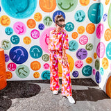 Thin, lightweight and stretchy set featuring fuchsia, orange, coral and ivory abstract print with 1/4 gold button front and collar on the short sleeved top and matching wide leg pants with elastic waist and pockets.