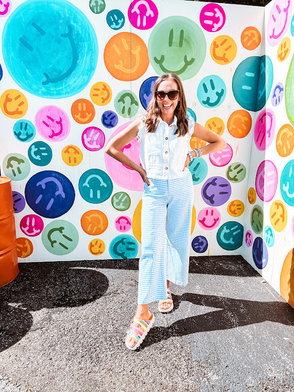 A crisp white twill vest that's equal parts polished and playful—those ruffled sleeves are the kind of detail that makes every outfit feel intentional. Button-down front, collar, and functional pockets.
