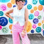 Soft, chic white button vest with gold shell and sun faux buttons down the front and a peekaboo front hem, round neck.