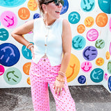 Soft, chic white button vest with gold shell and sun faux buttons down the front and a peekaboo front hem, round neck.
