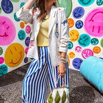 Cream fitted blazer with vibrant floral embroidery and French embroidered —"j'taime," "amour," "bisou, bisou"—with structured shoulder padding and scrunched sleeves.