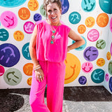 Fuchsia set including a bubble hem, sleeveless blouse with pleated shoulders and wide-leg pants with pockets.