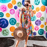 This tropical print short dress features vibrant summer hues with playful striping and fruit motifs throughout, square smocked neckline and flutter sleeves and pockets—complete with pink and blue ball tassels. Crafted from soft, lightweight fabric, it's designed to move with you all day long.