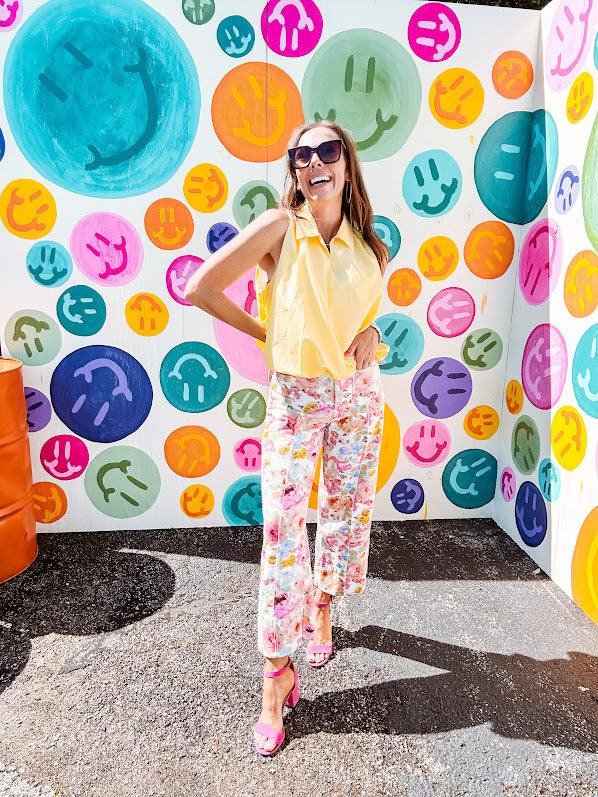 Buttery yellow sleeveless collared tank with V-neck design and structured collar and fully lined bodice and bubble hem.