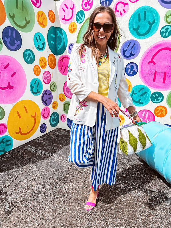 Cream fitted blazer with vibrant floral embroidery and French embroidered —"j'taime," "amour," "bisou, bisou"—with structured shoulder padding and scrunched sleeves.