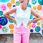 Soft, chic white button vest with gold shell and sun faux buttons down the front and a peekaboo front hem, round neck.