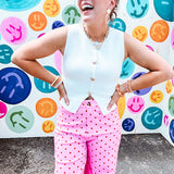 Soft, chic white button vest with gold shell and sun faux buttons down the front and a peekaboo front hem, round neck.