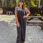 Cotton washed black jumpsuit with adjustable straps and wide leg design
