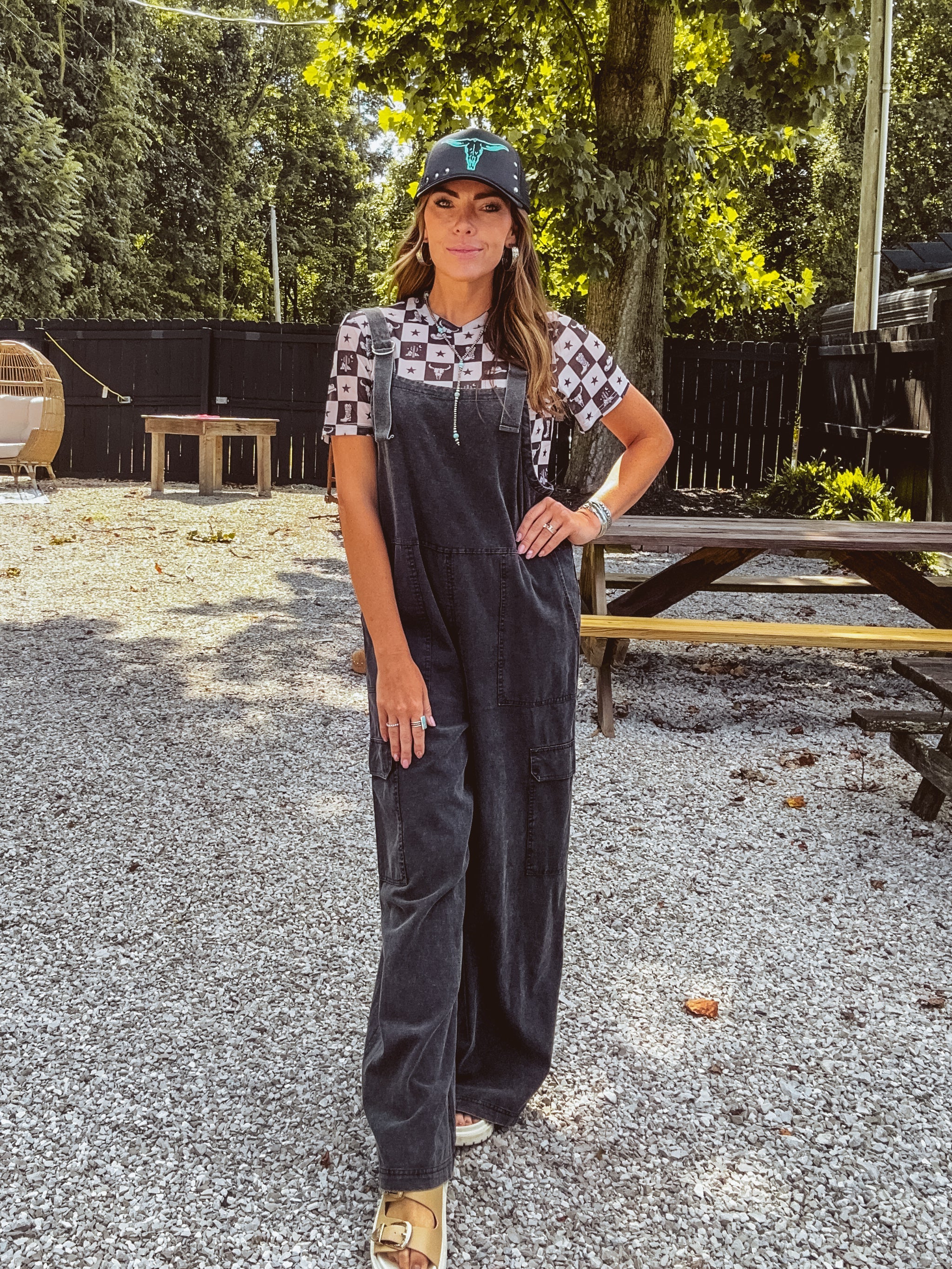 Cotton washed black jumpsuit with adjustable straps and wide leg design