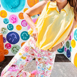 Buttery yellow sleeveless collared tank with V-neck design and structured collar and fully lined bodice and bubble hem.