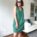 Terry-like forest green sleeveless hoodie dress with drawstring. Mini length.