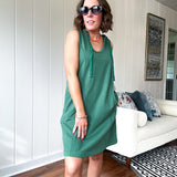 Terry-like forest green sleeveless hoodie dress with drawstring. Mini length.