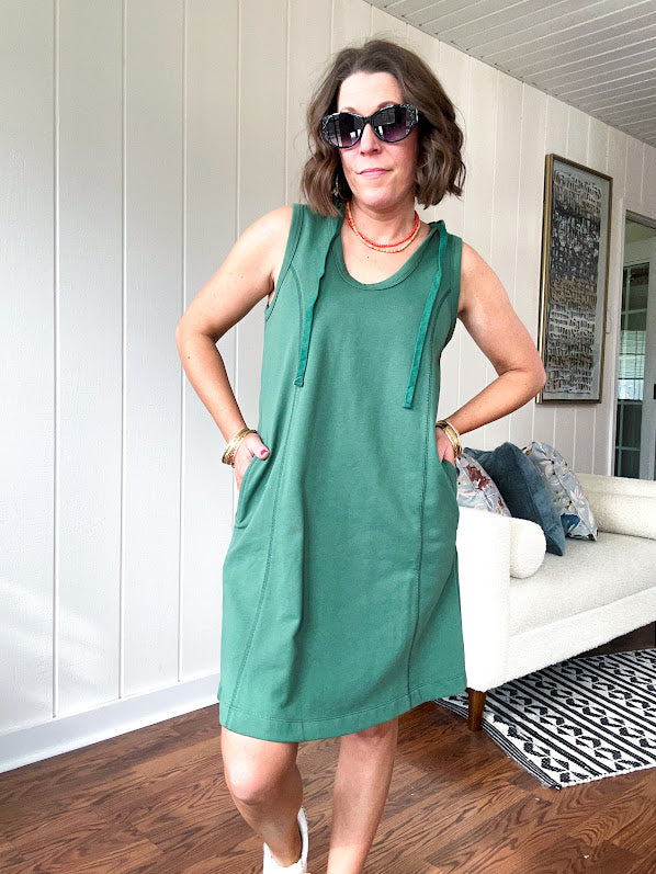 Terry-like forest green sleeveless hoodie dress with drawstring. Mini length.