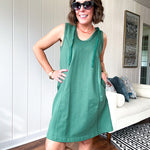 Terry-like forest green sleeveless hoodie dress with drawstring. Mini length.