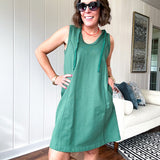 Terry-like forest green sleeveless hoodie dress with drawstring. Mini length.