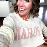 Nearly sheer soft, woven cream sweater with coral "MARGS" on the front.