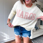 Nearly sheer soft, woven cream sweater with coral "MARGS" on the front.