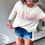 Nearly sheer soft, woven cream sweater with coral "MARGS" on the front.