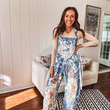 Denim patchwork overalls with tied adjustable straps, lace tied sides and floral and butterfly patches throughout.