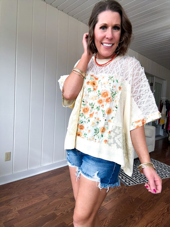 Cream lace crochet dolman style tee with orange and green floral patch and trim. Oversized.