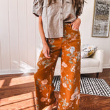 Dark mustard denim stretch pants with vintage floral print, button zipper closure, wide leg and raw hem.