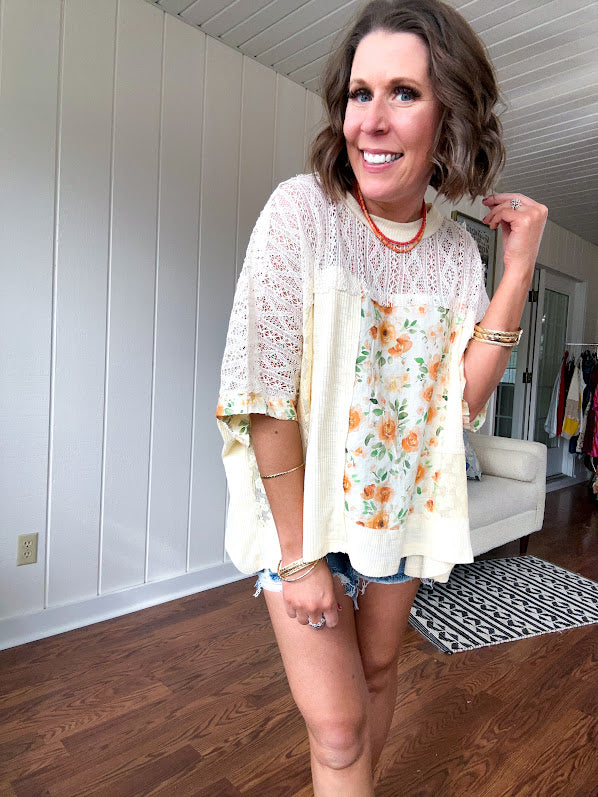 Cream lace crochet dolman style tee with orange and green floral patch and trim. Oversized.