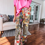Cotton wide leg pants featuring an elastic back, button zipper closure and bright floral, bee and leopard print patchwork throughout with sparkling embellishments.