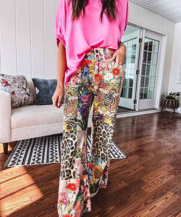 Cotton wide leg pants featuring an elastic back, button zipper closure and bright floral, bee and leopard print patchwork throughout with sparkling embellishments.