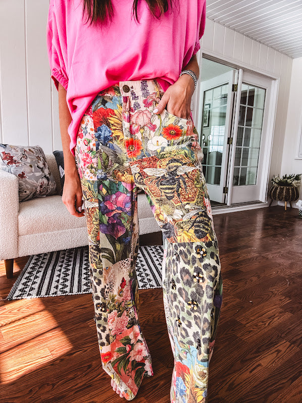 Cotton wide leg pants featuring an elastic back, button zipper closure and bright floral, bee and leopard print patchwork throughout with sparkling embellishments.