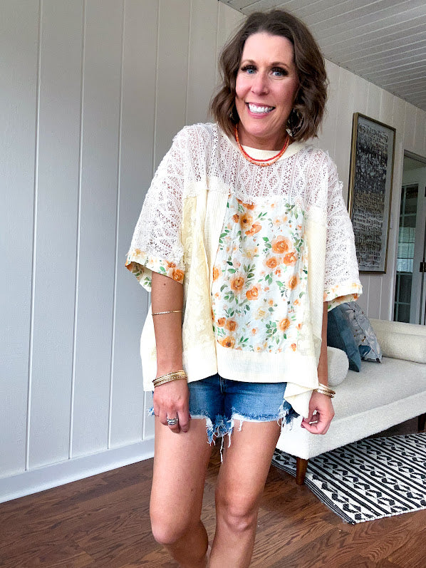 Cream lace crochet dolman style tee with orange and green floral patch and trim. Oversized.