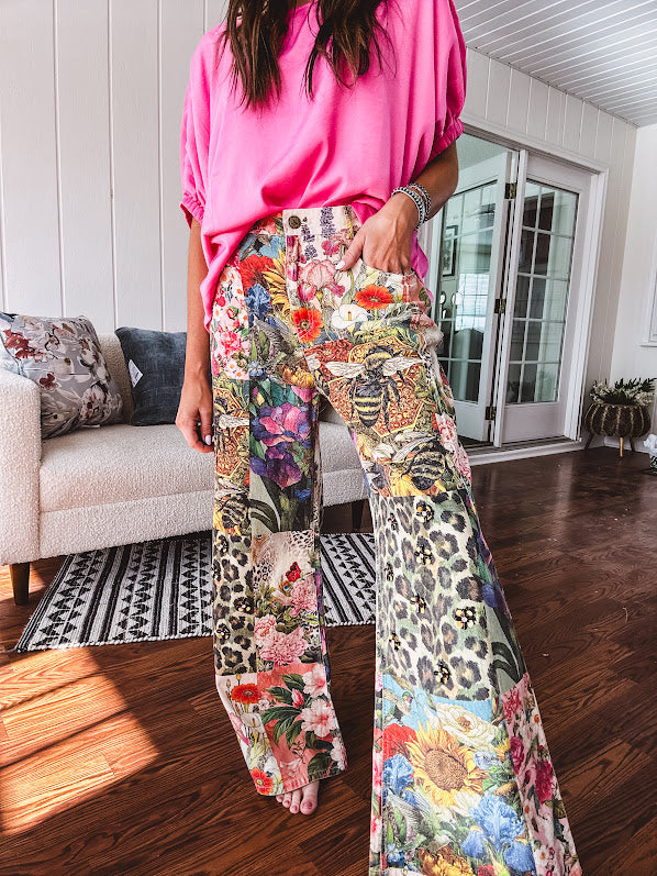 Cotton wide leg pants featuring an elastic back, button zipper closure and bright floral, bee and leopard print patchwork throughout with sparkling embellishments.