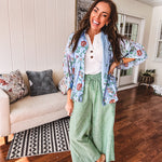 Lightweight denim blue button down blouse with sheer, long sleeves, vintage floral print.