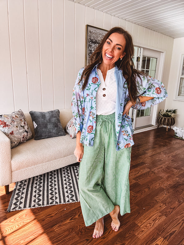 Lightweight denim blue button down blouse with sheer, long sleeves, vintage floral print.