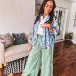 Lightweight green and white wide leg pants with elastic drawstring waist.