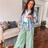 Lightweight green and white wide leg pants with elastic drawstring waist.