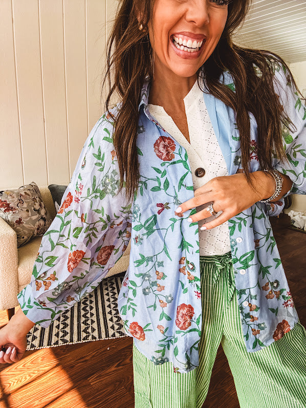 Lightweight denim blue button down blouse with sheer, long sleeves, vintage floral print.