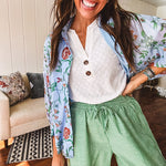 Lightweight denim blue button down blouse with sheer, long sleeves, vintage floral print.