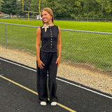 Textured black knit sleeveless top with wooden buttons down the front.