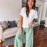 Lightweight green and white wide leg pants with elastic drawstring waist.