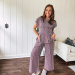 Plum and white gingham set with round neck top with smocking detail throughout and scalloped short sleeves and elastic waist wide leg pants with scalloped hem.