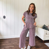 Plum and white gingham set with round neck top with smocking detail throughout and scalloped short sleeves and elastic waist wide leg pants with scalloped hem.