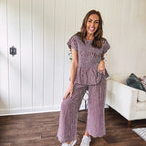 Plum and white gingham set with round neck top with smocking detail throughout and scalloped short sleeves and elastic waist wide leg pants with scalloped hem.