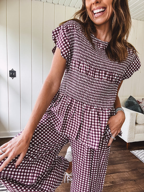 Plum and white gingham set with round neck top with smocking detail throughout and scalloped short sleeves and elastic waist wide leg pants with scalloped hem.
