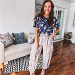 Navy short sleeved cotton top with ivory western motif print, waist length, cuffed sleeves.