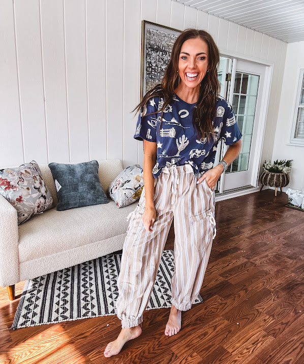 Navy short sleeved cotton top with ivory western motif print, waist length, cuffed sleeves.