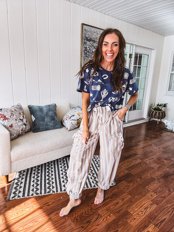 Navy short sleeved cotton top with ivory western motif print, waist length, cuffed sleeves.