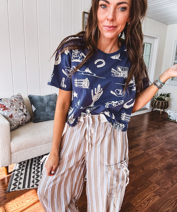 Navy short sleeved cotton top with ivory western motif print, waist length, cuffed sleeves.