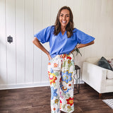 Textured ocean blue puff sleeve top with scalloped hem and mock neck with V neck front.
